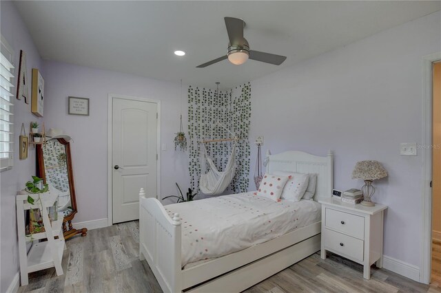 bedroom with ceiling fan and light wood-type flooring