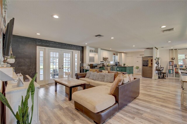 living room featuring light wood-type flooring and french doors