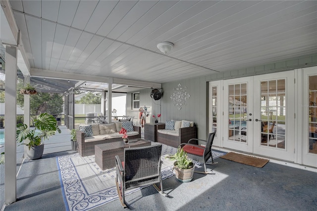 sunroom / solarium featuring french doors