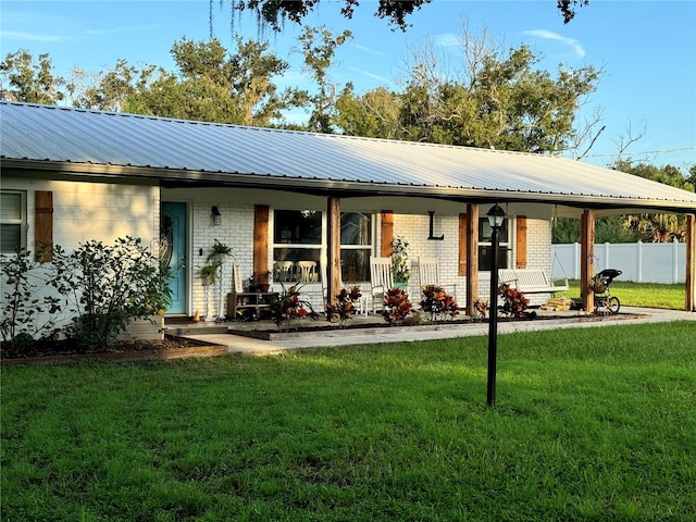 back of property featuring a yard and a porch