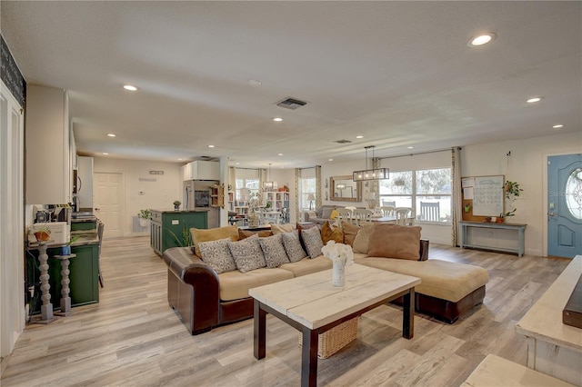 7809 Alafia Dr, Riverview, FL 33578 - living area featuring light wood finished floors and recessed lighting