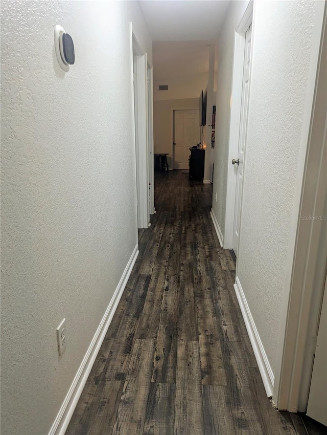 hallway featuring dark hardwood / wood-style flooring