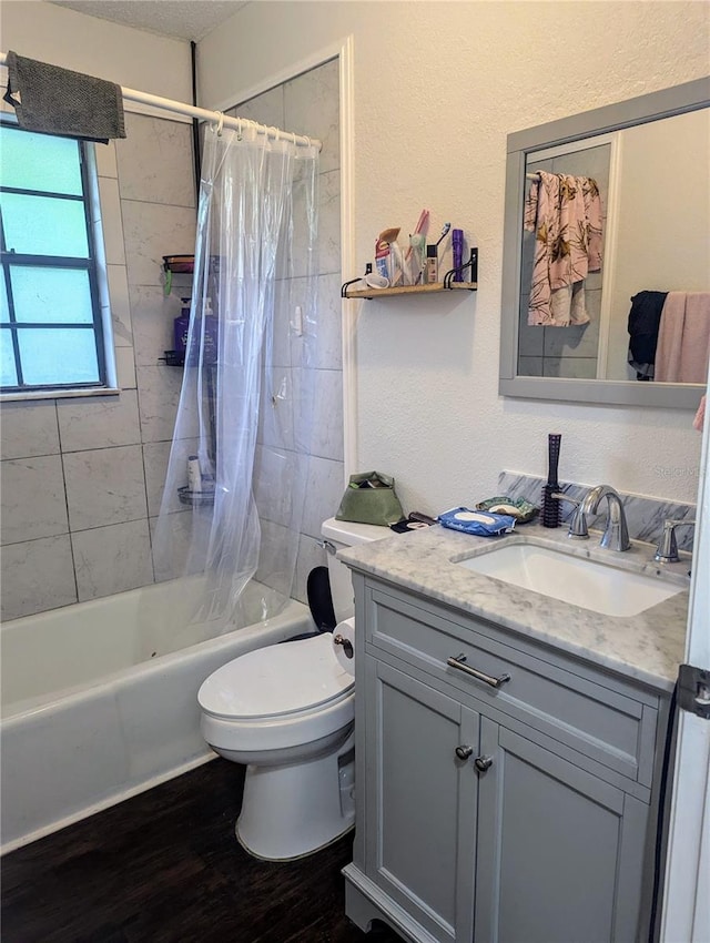 full bathroom featuring vanity, toilet, hardwood / wood-style floors, and shower / bath combo