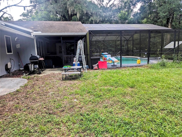 view of yard with glass enclosure