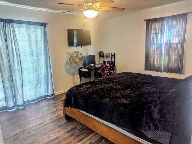 bedroom with a textured ceiling, hardwood / wood-style floors, and ceiling fan