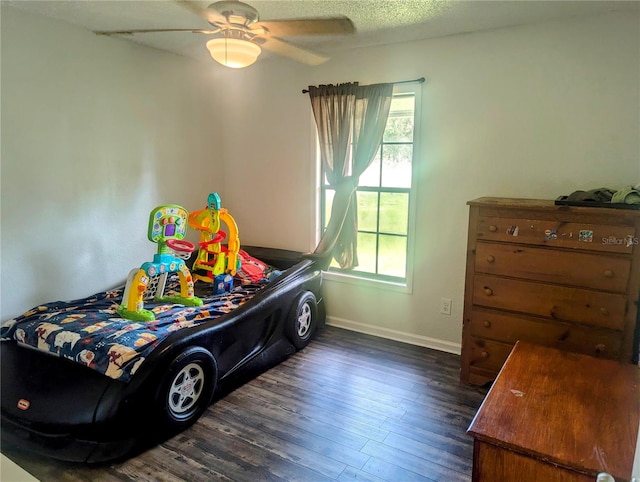 bedroom featuring dark wood-type flooring and ceiling fan