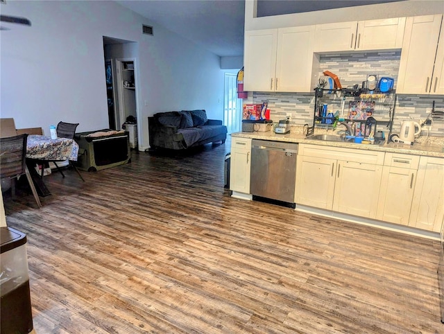 kitchen featuring dishwasher, hardwood / wood-style floors, backsplash, and sink