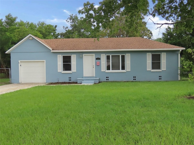 ranch-style house featuring a garage and a front yard