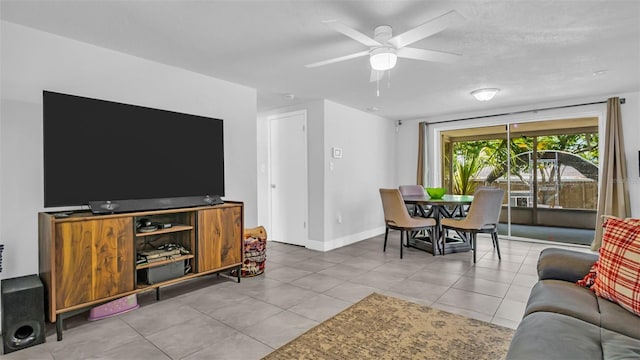 living room featuring ceiling fan and light tile patterned flooring