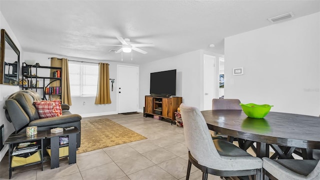 tiled dining area with ceiling fan