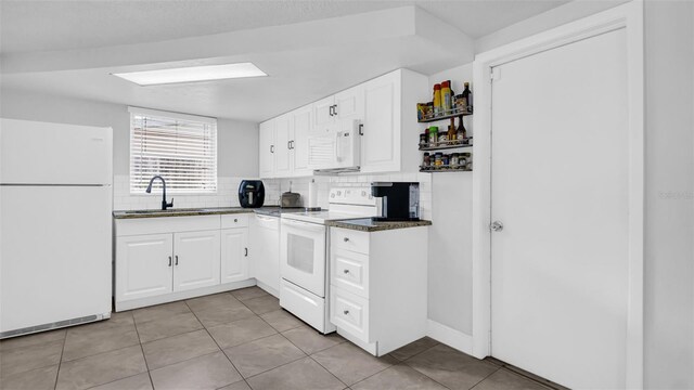 kitchen with sink, white cabinets, white appliances, and light tile patterned floors