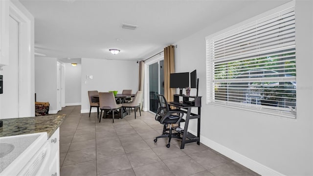 dining area featuring visible vents, baseboards, and light tile patterned floors