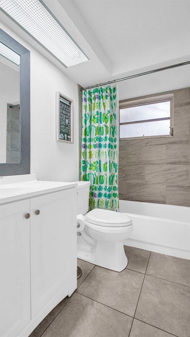 bathroom with toilet, tile patterned floors, shower / tub combo with curtain, and vanity