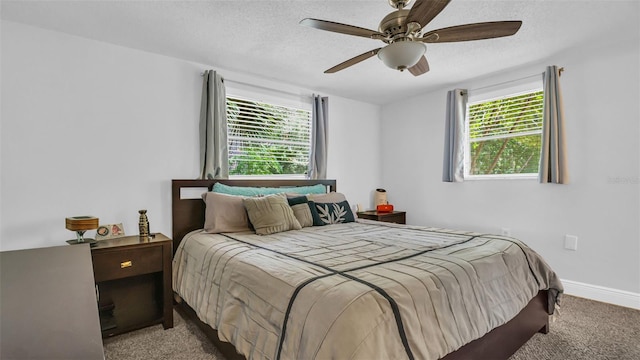 bedroom with ceiling fan, a textured ceiling, and carpet