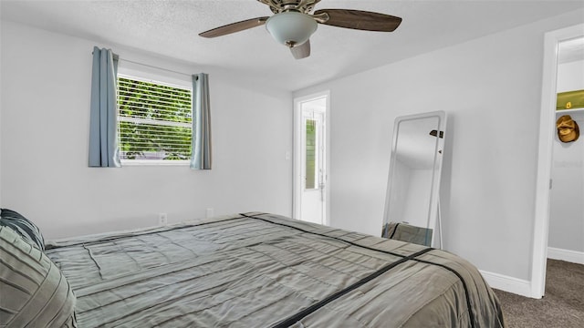 bedroom with carpet, ceiling fan, a textured ceiling, and baseboards