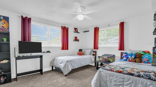 bedroom with a textured ceiling, ceiling fan, multiple windows, and carpet