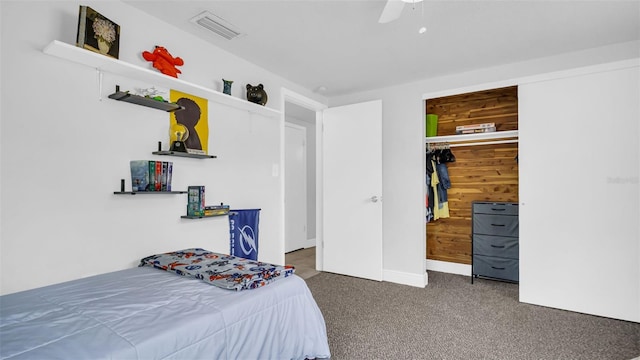 bedroom featuring ceiling fan, dark colored carpet, and visible vents
