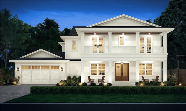 view of front of house with a balcony, a front lawn, and a garage