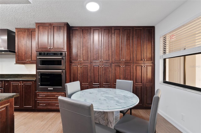 interior space with a textured ceiling and light hardwood / wood-style floors