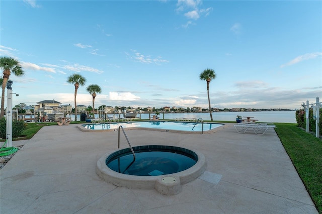 view of pool featuring a patio, a community hot tub, and a water view