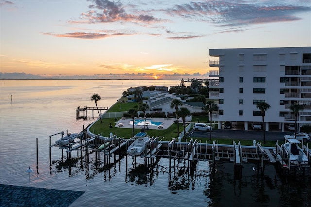 view of dock featuring a water view and a pool