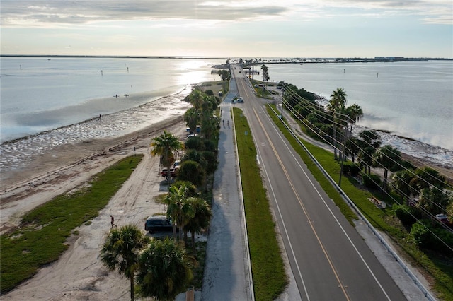 bird's eye view with a water view and a beach view