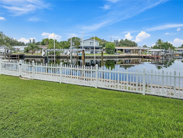 dock area with a yard and a water view