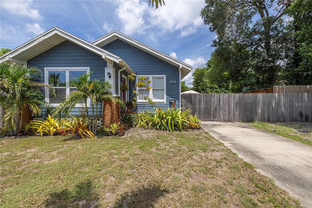 bungalow-style home with a front lawn