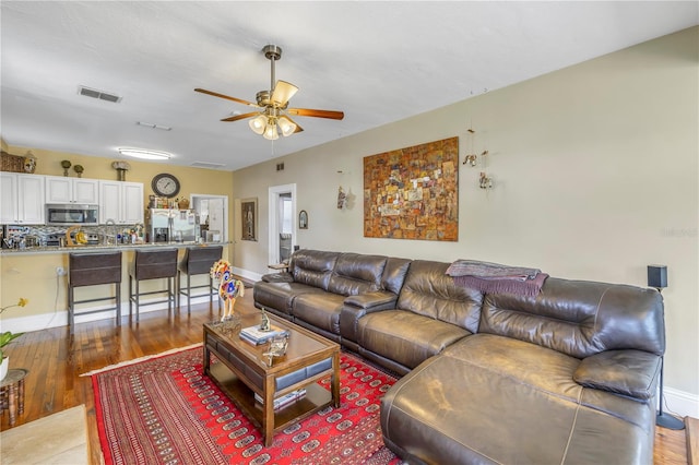 living room with light hardwood / wood-style floors and ceiling fan