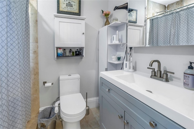 bathroom featuring toilet, vanity, and tile patterned flooring