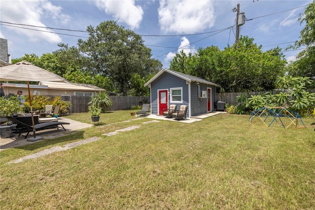 view of yard with an outbuilding and a patio