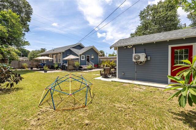 view of yard featuring a patio, an outdoor structure, and ac unit