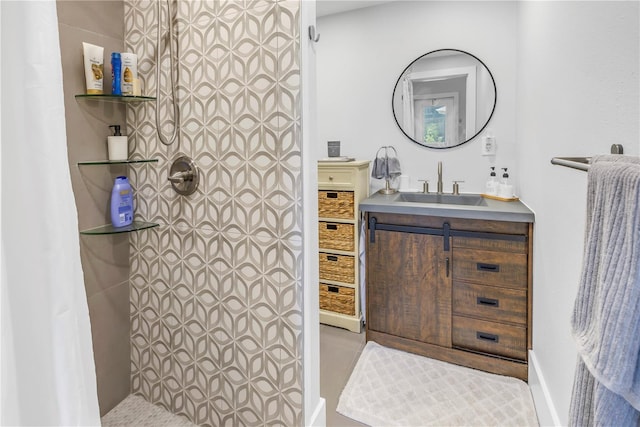 bathroom featuring a shower and vanity