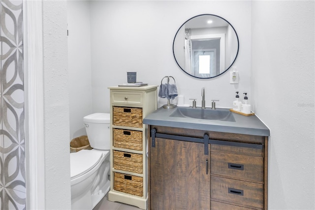 bathroom with vanity and toilet