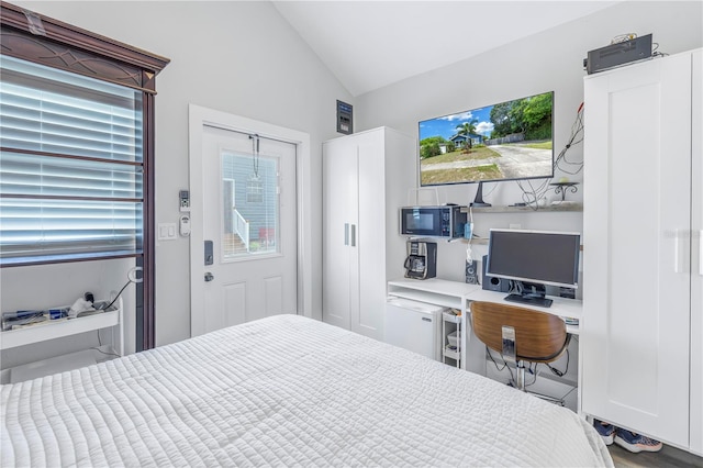 bedroom with lofted ceiling and hardwood / wood-style floors