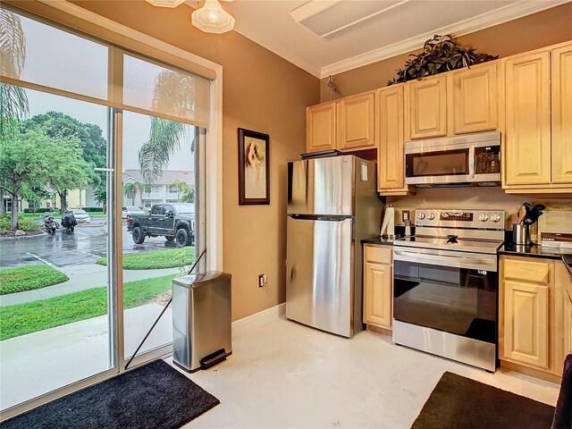 kitchen featuring appliances with stainless steel finishes and crown molding