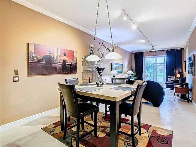 dining room featuring baseboards, finished concrete flooring, rail lighting, and crown molding