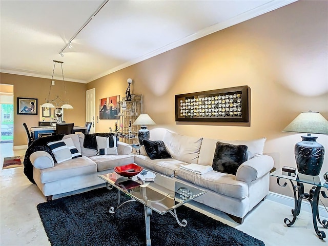 living area with rail lighting, baseboards, ornamental molding, and concrete flooring