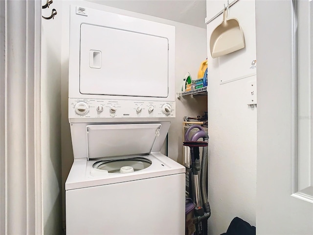 laundry area featuring stacked washer and dryer and laundry area