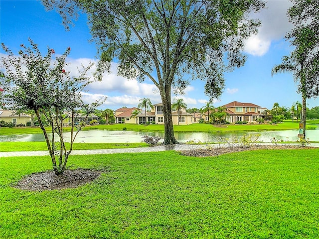 view of yard featuring a residential view and a water view