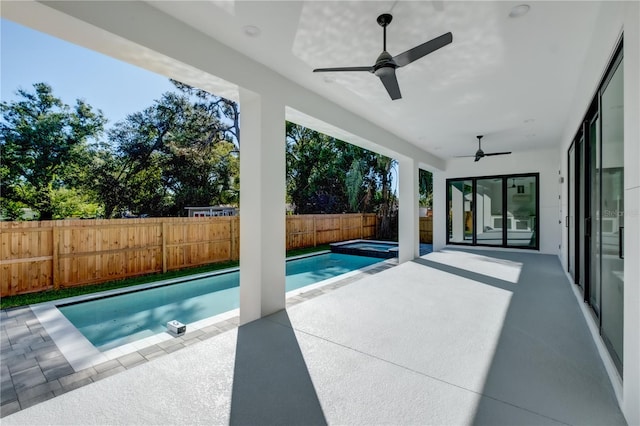 view of swimming pool featuring ceiling fan and a patio area