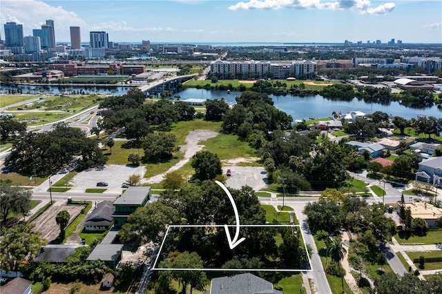 birds eye view of property featuring a water view and a city view