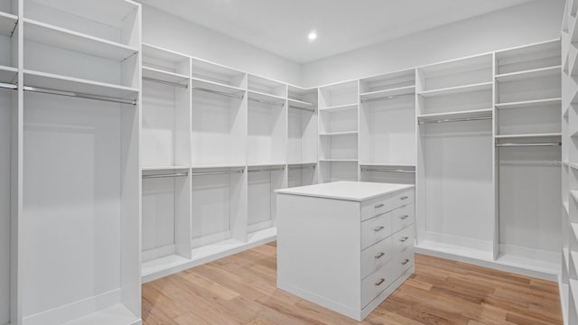 walk in closet with light wood-type flooring