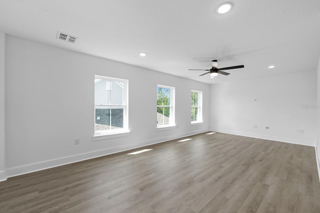 empty room featuring hardwood / wood-style floors and ceiling fan