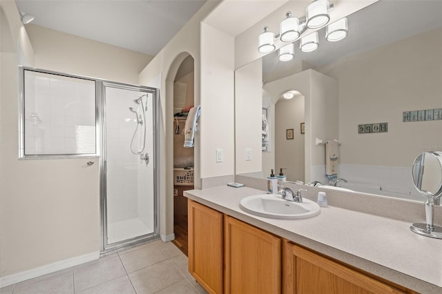 bathroom featuring vanity, tile patterned flooring, and a shower with shower door