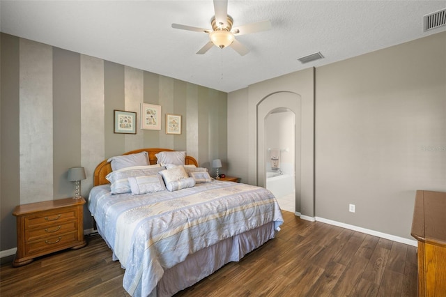 bedroom featuring ceiling fan, dark hardwood / wood-style floors, and a textured ceiling