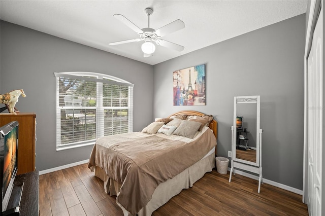 bedroom with ceiling fan and dark hardwood / wood-style flooring