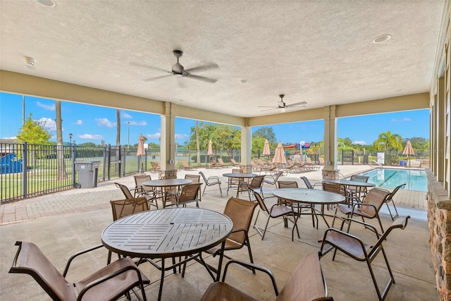 view of patio / terrace featuring ceiling fan and a community pool