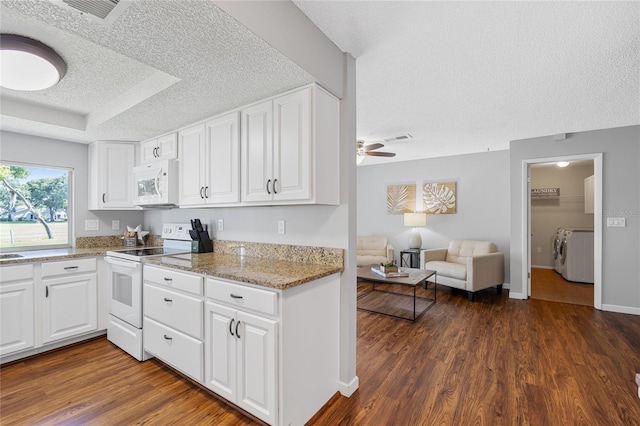 kitchen with white appliances, ceiling fan, white cabinets, and dark hardwood / wood-style flooring