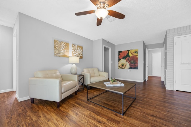 living room with hardwood / wood-style floors, ceiling fan, and a textured ceiling